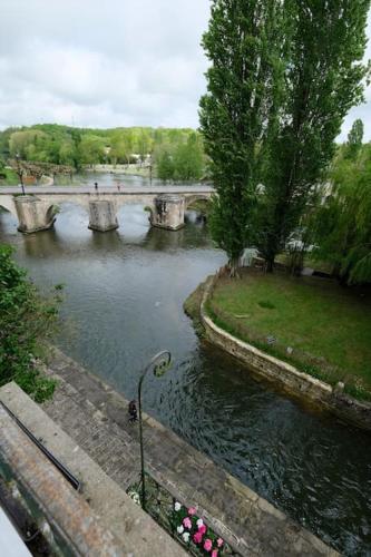 a view of a river with a bridge at Lavilladouce in Moret-sur-Loing