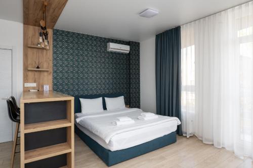 a bedroom with a bed and a green wall at Nyvky Residence in Kyiv