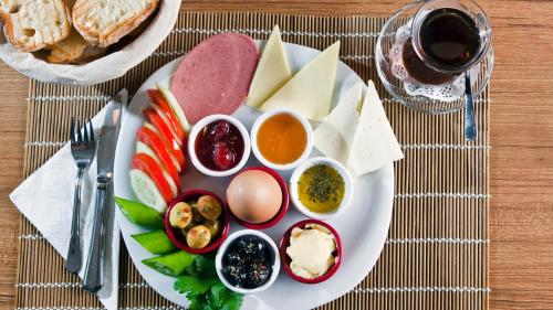 a plate with different types of food on a table at Sultanahmet Nu Hotel in Istanbul