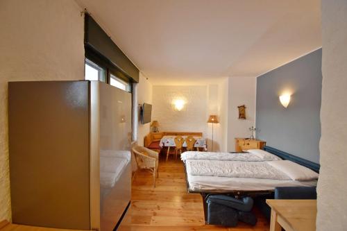 a room with two beds and a table in it at SISSI Apartment in Madonna di Campiglio