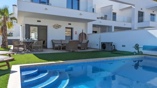a villa with a swimming pool and a patio at PANORAMIC pool & mountains house in Finestrat