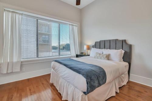 a bedroom with a large bed and a window at Sky Suite at 300 Drayton in Savannah