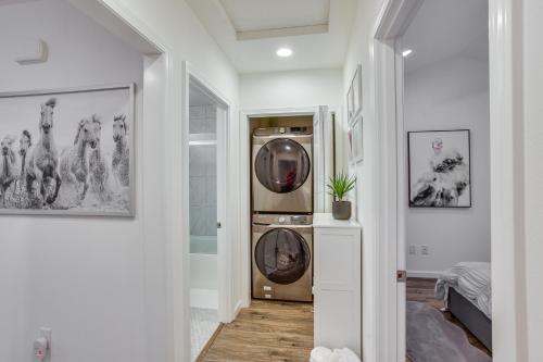 a hallway with a washer and dryer at Newly Built Maple Valley Vacation Rental with Patio! in Maple Valley