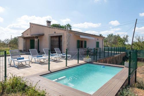 a small swimming pool with chairs and a house at Can Taco in Llucmajor