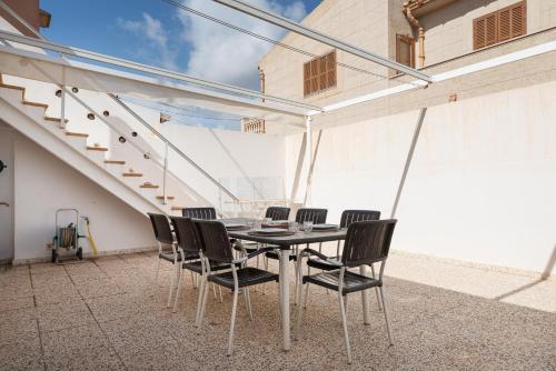 a dining room table and chairs on a patio at Vent de Xaloc in Sa Ràpita