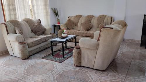 La Molina的住宿－Los Girasoles，客厅配有几张沙发和一张桌子