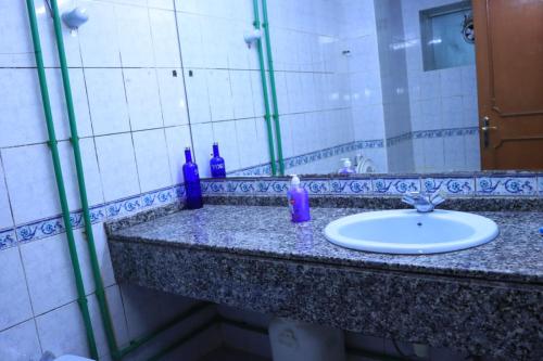 a bathroom counter with a sink and a mirror at Al Seef View in Dubai