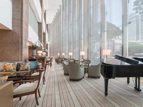
a living room filled with furniture and a large window at Discovery Primea in Manila
