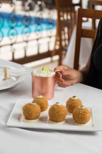 a person sitting at a table with a plate of food at Terra dos Diamantes Hotel in Lençóis
