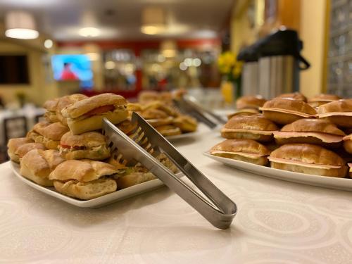 a table with two plates of pastries and a knife at Hotel El Puma in Cusco