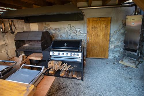 a kitchen with a stove and a stone wall at Penzion Pod kapličkou in Tišnov