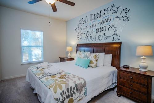 a bedroom with a bed and a wall with writing on it at Townhome at West Lucaya Resort 3202 in Orlando