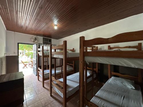 a room with several bunk beds and a patio at PANTANAL SANTA CLARA in Corumbá