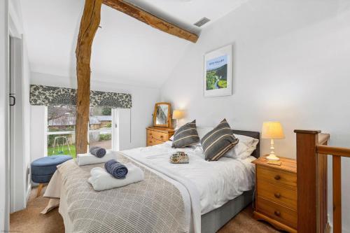 a bedroom with two beds and a window at Welsh Cottage in Little Marcle