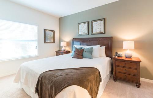 a bedroom with a large bed and a window at Townhome at West Lucaya Resort 3212 in Orlando