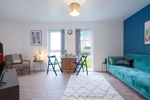 a living room with a blue couch and a table at Modern Apartment - Walking Distance to the City Centre - Free Parking, Fast Wi-Fi and Smart TV with Netflix by Yoko Property in Coventry