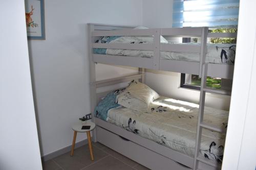 a white bunk bed in a room with a window at Dpto Pucón, camino al volcán in Pucón