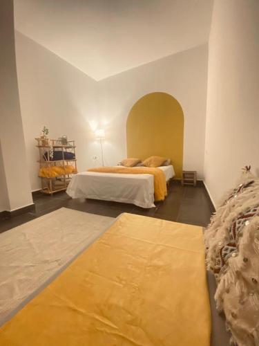 a bedroom with two beds in a room at Med tangier apartment -tanger med port 