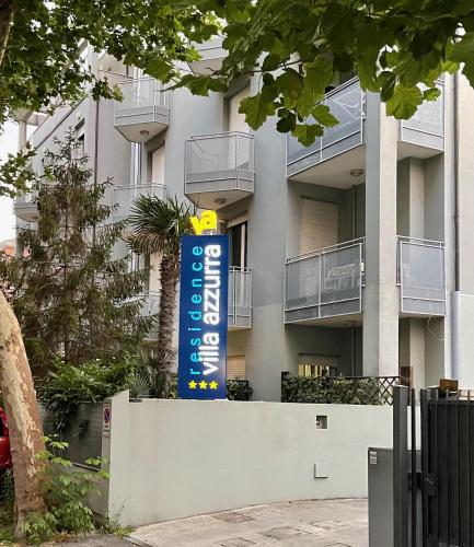 a blue sign in front of a building at Residence Villa Azzurra in Rimini