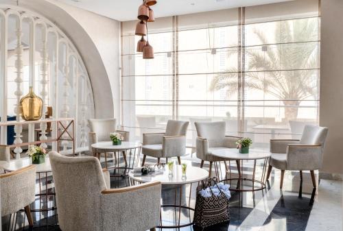 a restaurant with tables and chairs and a large window at TUI BLUE Scheherazade Adults Only - All Inclusive in Sousse