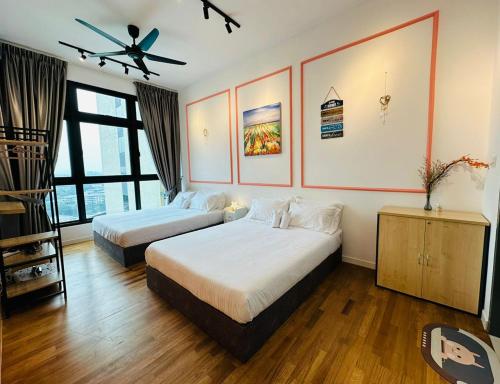 a bedroom with two beds and a ceiling fan at Peachy Poolview Paradise @ Paradigm Mall *10-12pax in Johor Bahru