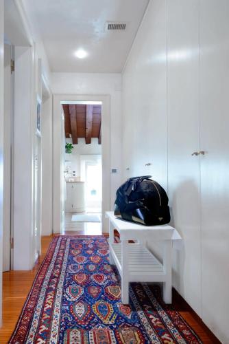 a room with a white table and a rug at Mini Suite Deluxe Isola di Mezzo in Treviso