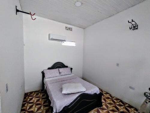 a small room with a bed in the corner at SAN SENDERISMO ROOM in Mariquita