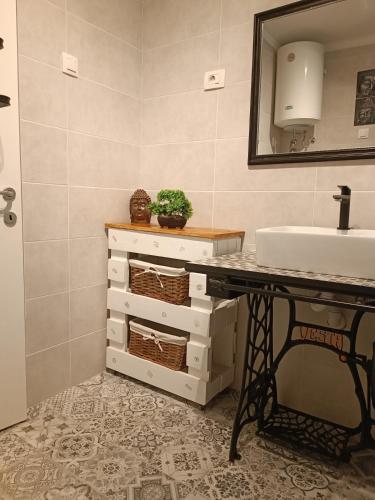 a bathroom with a sink and a counter with a sink at Apartment Bella in Ližnjan