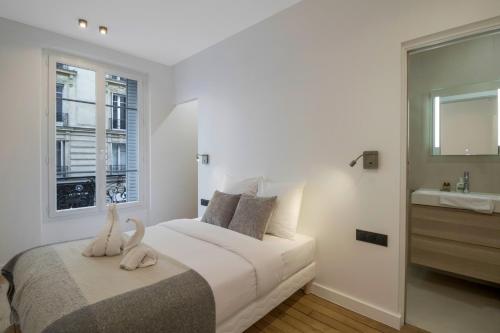 - une chambre dotée d'un lit avec deux cygnes dans l'établissement Luxueuses Suites - Arc de Triomphe - Trocadéro, à Paris