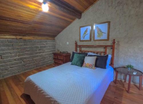 Un pat sau paturi într-o cameră la Chalé Casa de Pedra, Vivenda Serra Velha, Chalés de Montanha