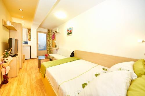 a hotel room with two beds and a television at Lazur Studio in Burgas City