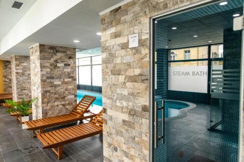 a lobby with a swimming pool and a sign in a building at Filo Hotel Wellness & Spa in Gheorgheni
