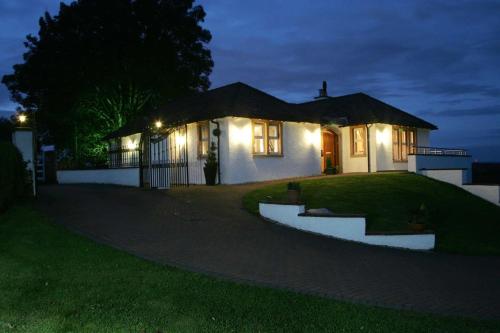 a house at night with lights in front of it at Ayrs and Graces - Luxury Bed and Breakfast in Ayr