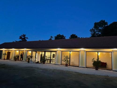 a large building with lights on it at night at Vitál Guesthouse in Almamellék