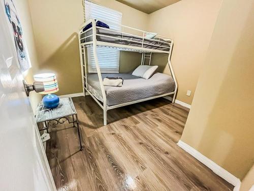 a small room with a bunk bed in a room at Urban Paradise: Stylish Getaway near Buschgardens in Tampa