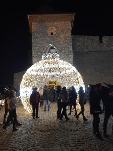 a group of people walking in front of a lit up building at Apartment Lady Daniela mit Meerblick in Lovran in Lovran