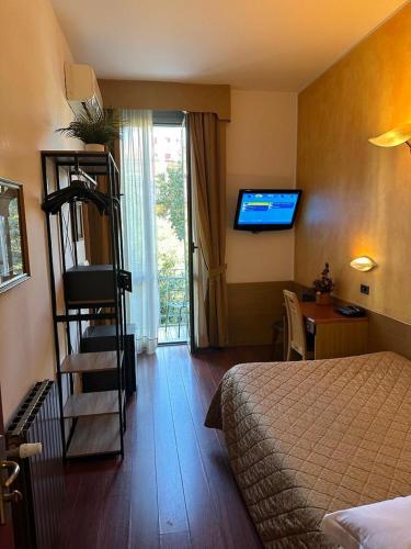 a hotel room with a room with a bed and a television at Hotel Aspromonte in Milan