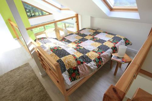 een slaapkamer met een bed met een quilt bij Orchard Nook - Sleeps 4, 2 Bedrooms (one ensuite) in Kendal