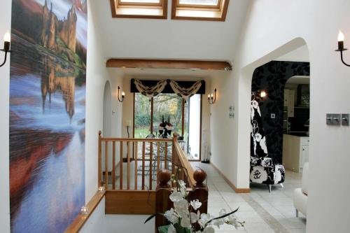 a hallway with a large painting on the wall at Ayrs and Graces - Luxury Bed and Breakfast in Ayr