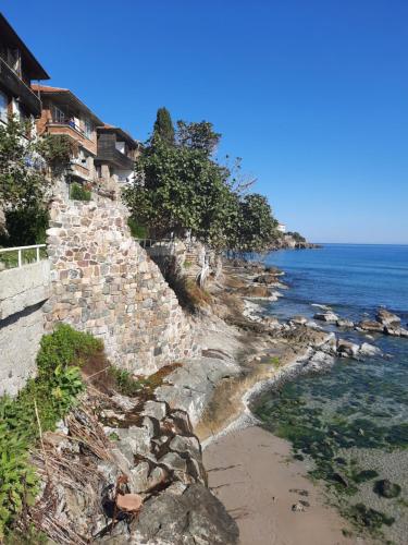 a stone retaining wall next to the ocean at Cozopol Budjaka in Sozopol