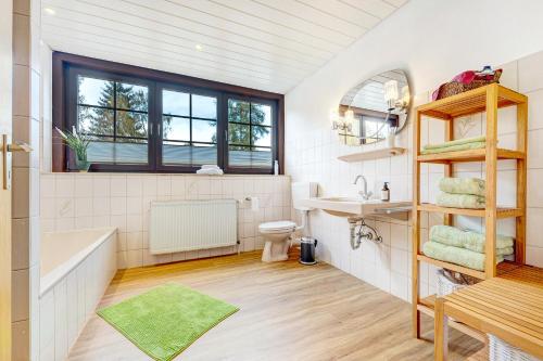 ein Badezimmer mit einer Badewanne, einem Waschbecken und einem WC in der Unterkunft Gästehaus am Mühlenteich in Schieder-Schwalenberg