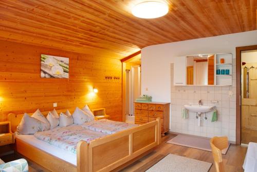 a bedroom with a bed and a sink at Haus Bergfrieden in Au im Bregenzerwald