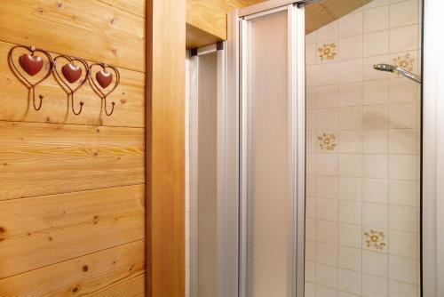 a bathroom with a shower with a glass door at Haus Bergfrieden in Au im Bregenzerwald