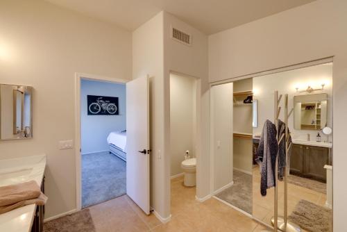 a bathroom with a toilet and a sink at Golf Course View and Pool Serene Glendale Home in Peoria