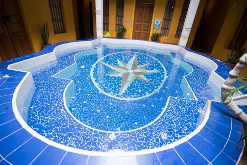a swimming pool with a star in the middle at La Brisa Loca Hostel in Santa Marta