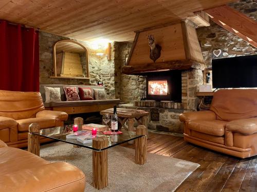 a living room with a couch and a fireplace at Chalet 1728 - La Reculaz - 2 minutes from Val D'isere by free shuttle bus in Tignes