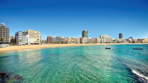 a view of a beach with two boats in the water at Duodecima in Las Palmas de Gran Canaria