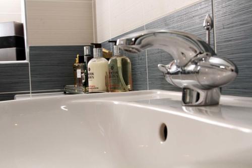 a sink with a faucet in a bathroom at Ayrs and Graces - Luxury Bed and Breakfast in Ayr