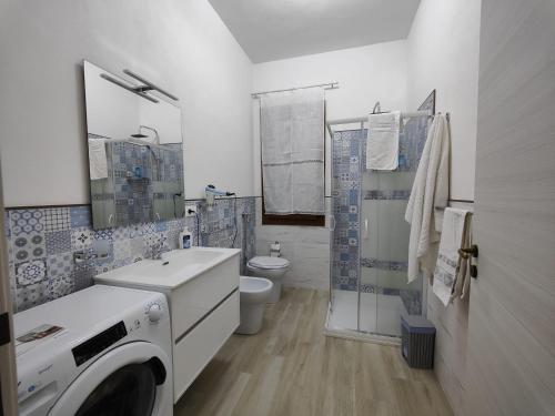 y baño con lavadora y secadora. en TRISCINA SELINUNTE BEACH, en Triscina