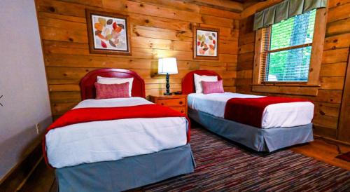 sypialnia z 2 łóżkami w drewnianym domku w obiekcie Wilderness Presidential Resort w mieście Spotsylvania